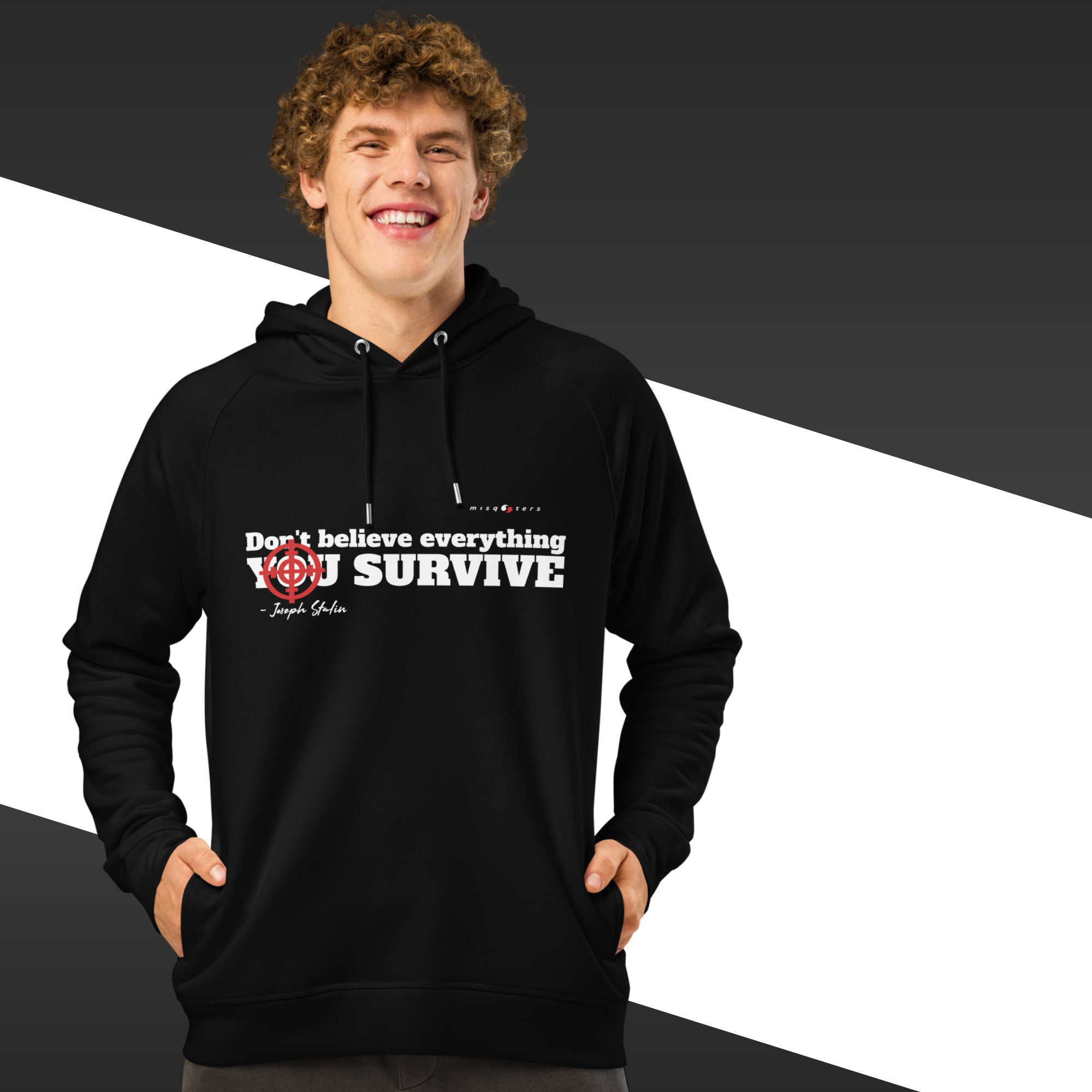 Man with black hoodie with a white text on and in the background there is black and white stripes