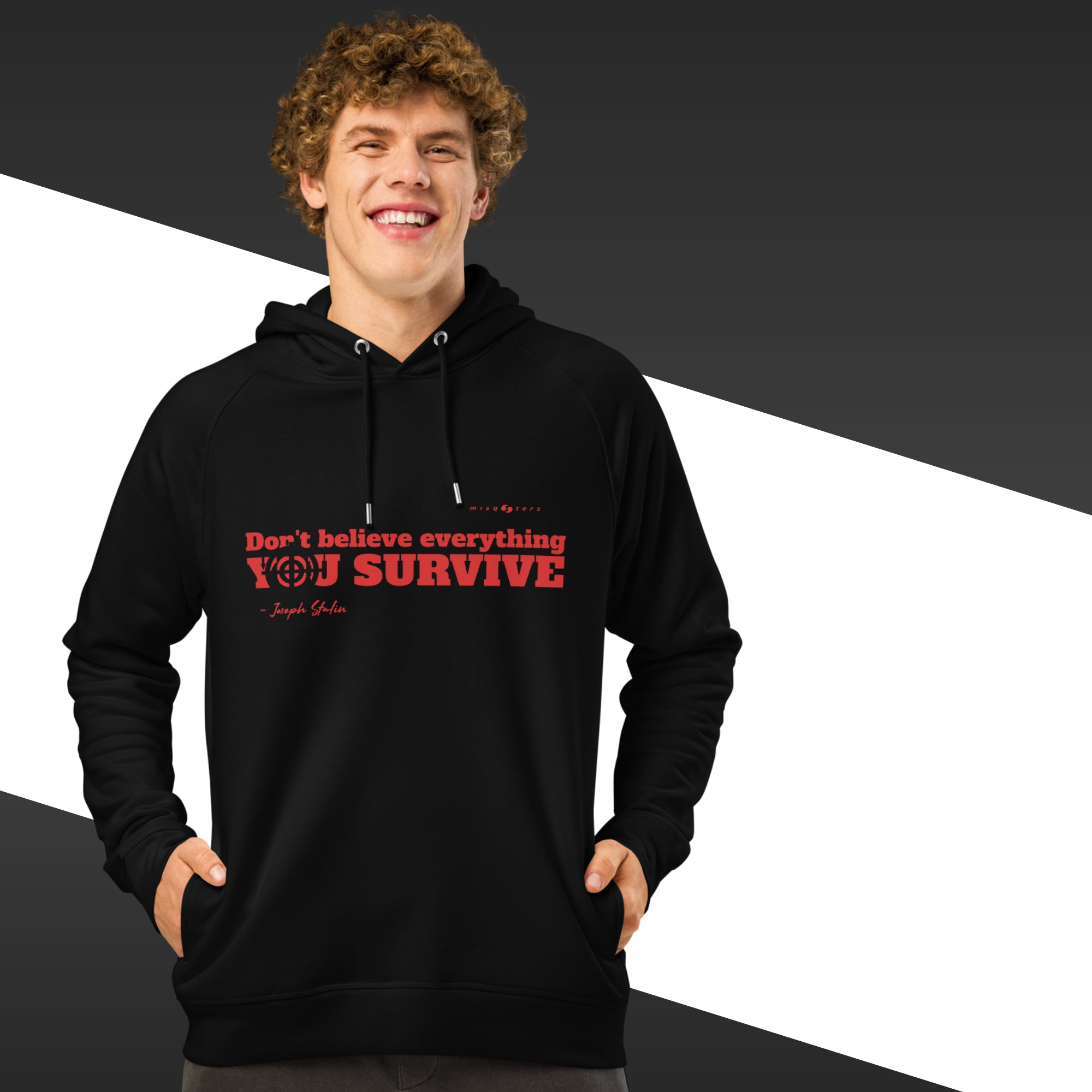 Man with black hoodie with a red text on and in the background there is black and white stripes