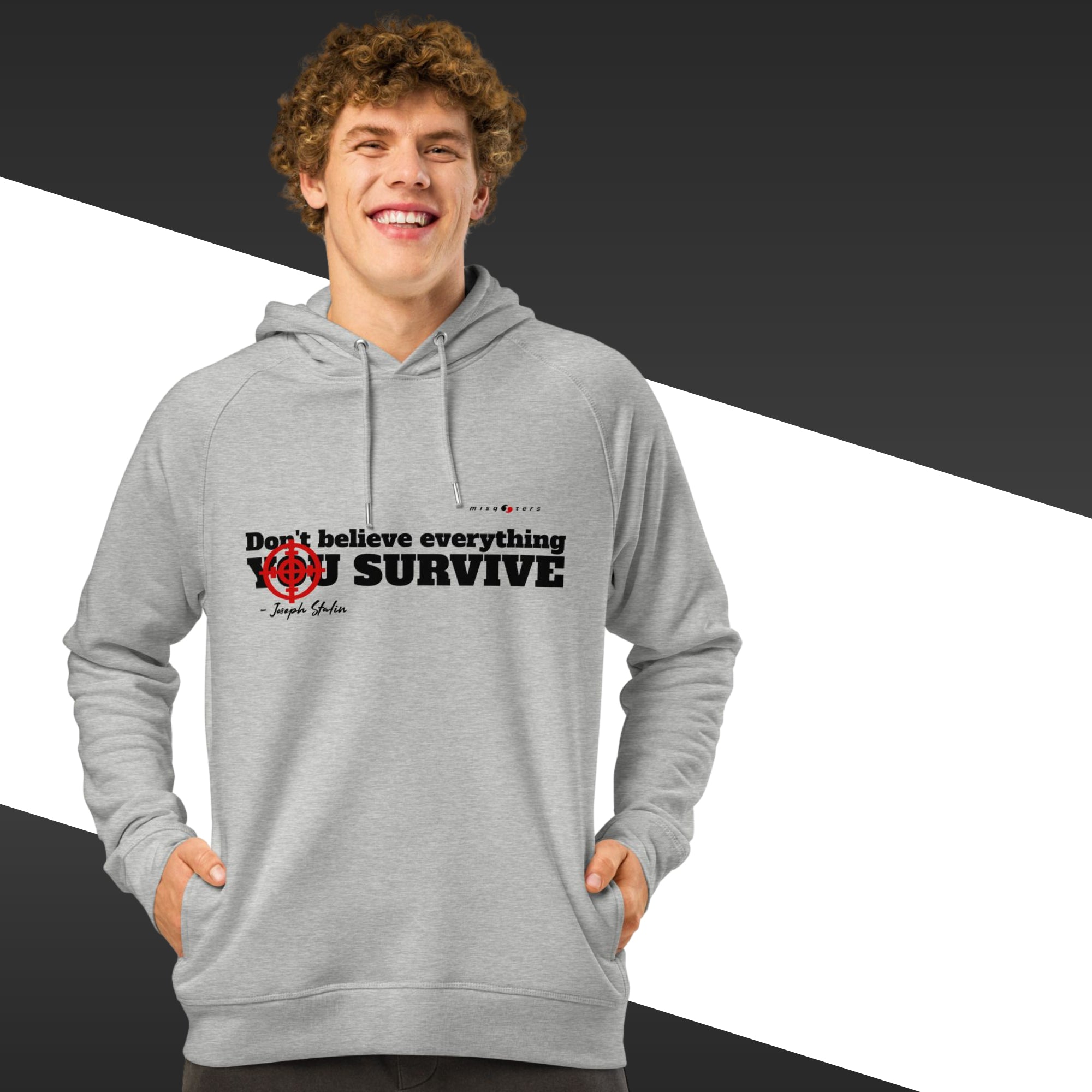 Man with grey hoodie with a black text on and in the background there is black and white stripes