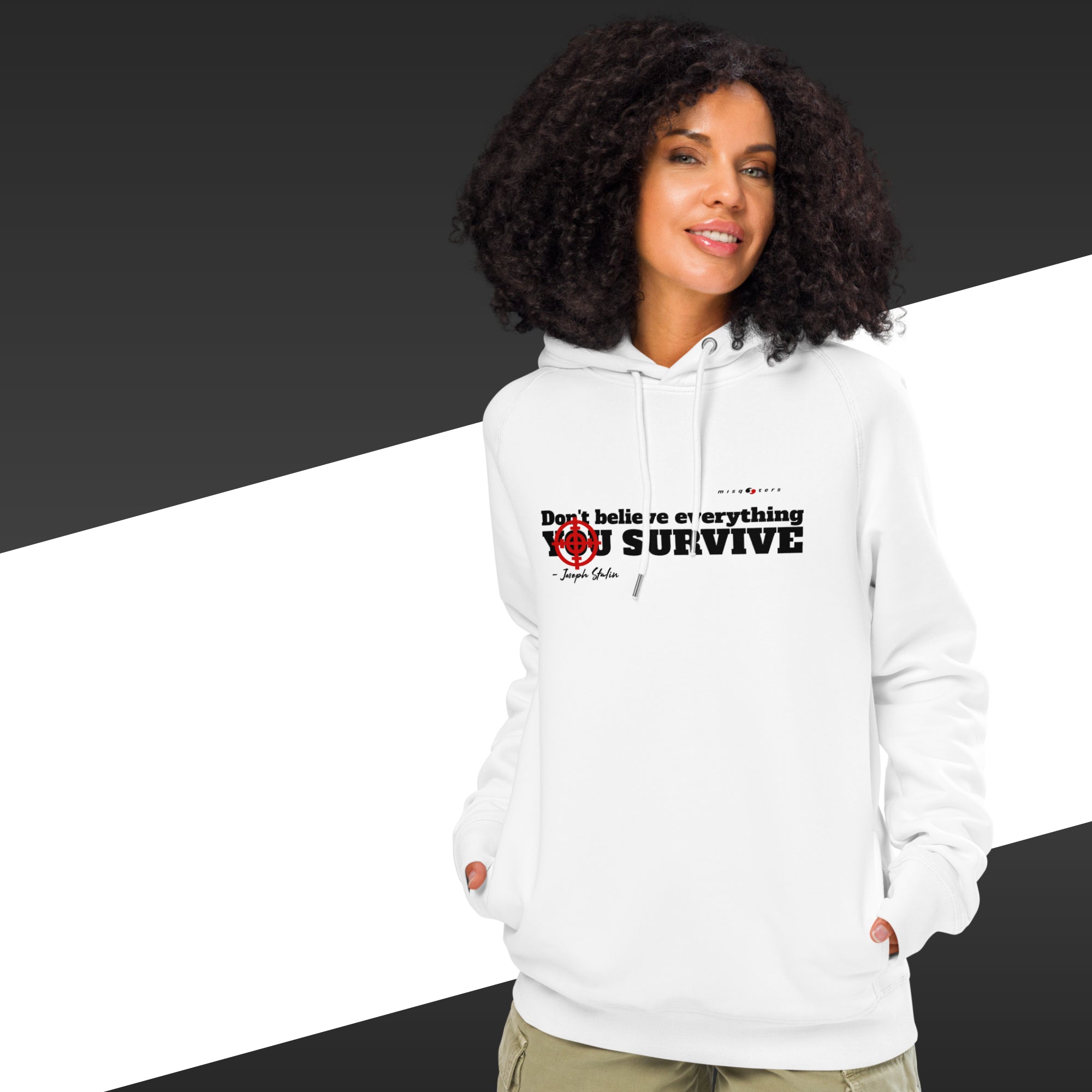 Woman with white hoodie with a black text on and in the background there is black and white stripes