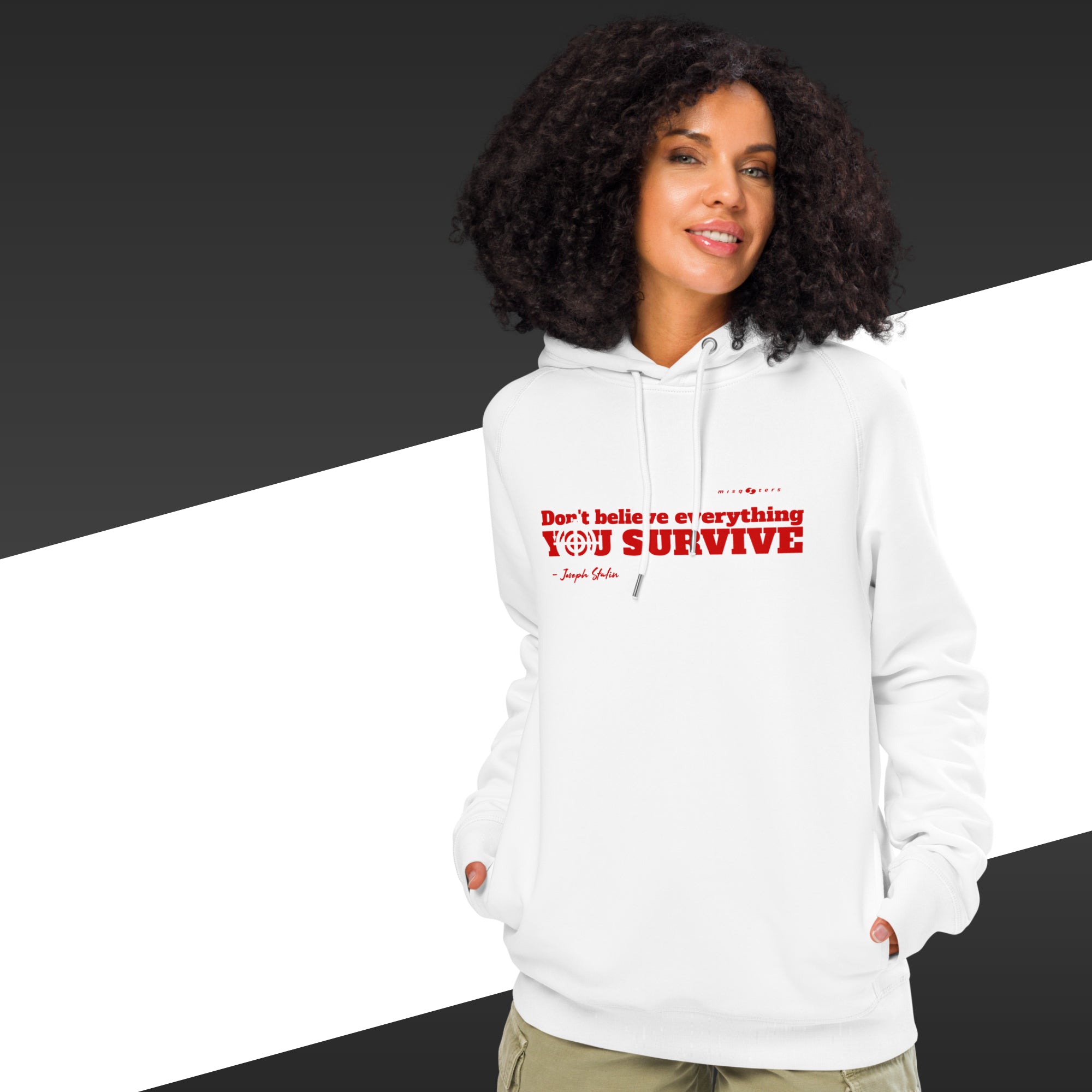 Woman with white hoodie with a red text on and in the background there is black and white stripes