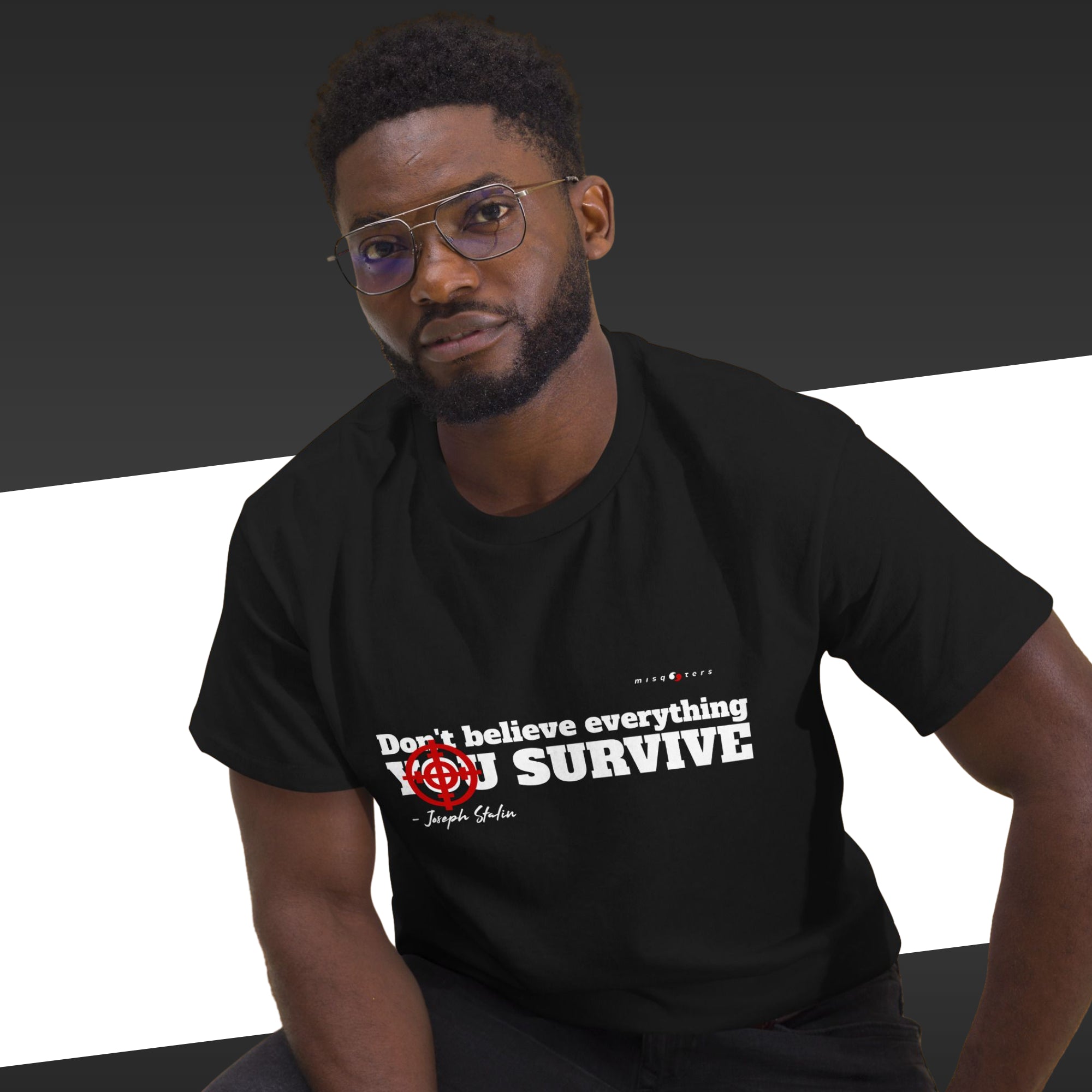 Man wearing a black t-shirt with text and graphics on a dark background