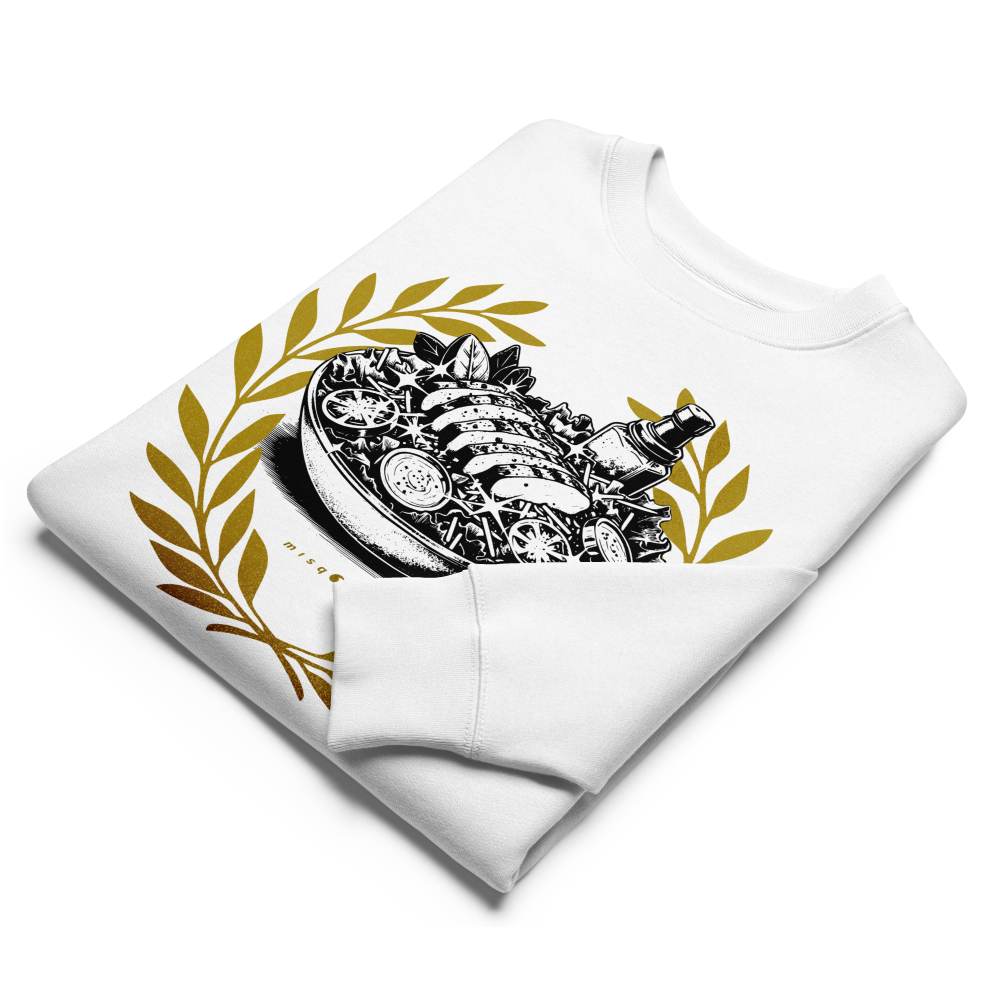 Folded white sweatshirt with intricate design and gold leaves on a white background
