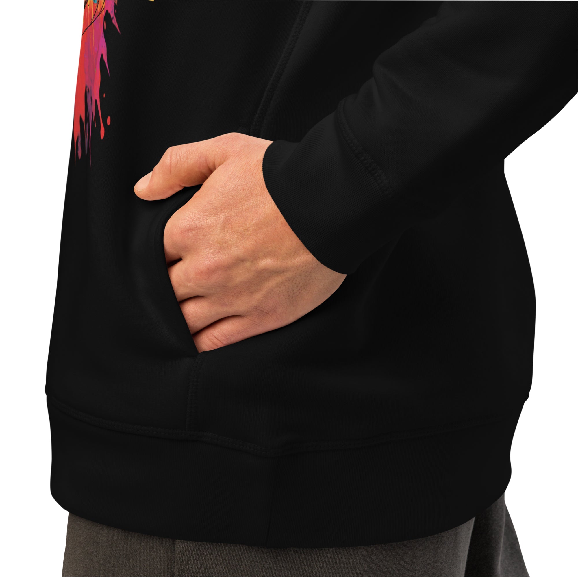 Person wearing a black hoodie with colorful design on sleeve, hand in pocket.