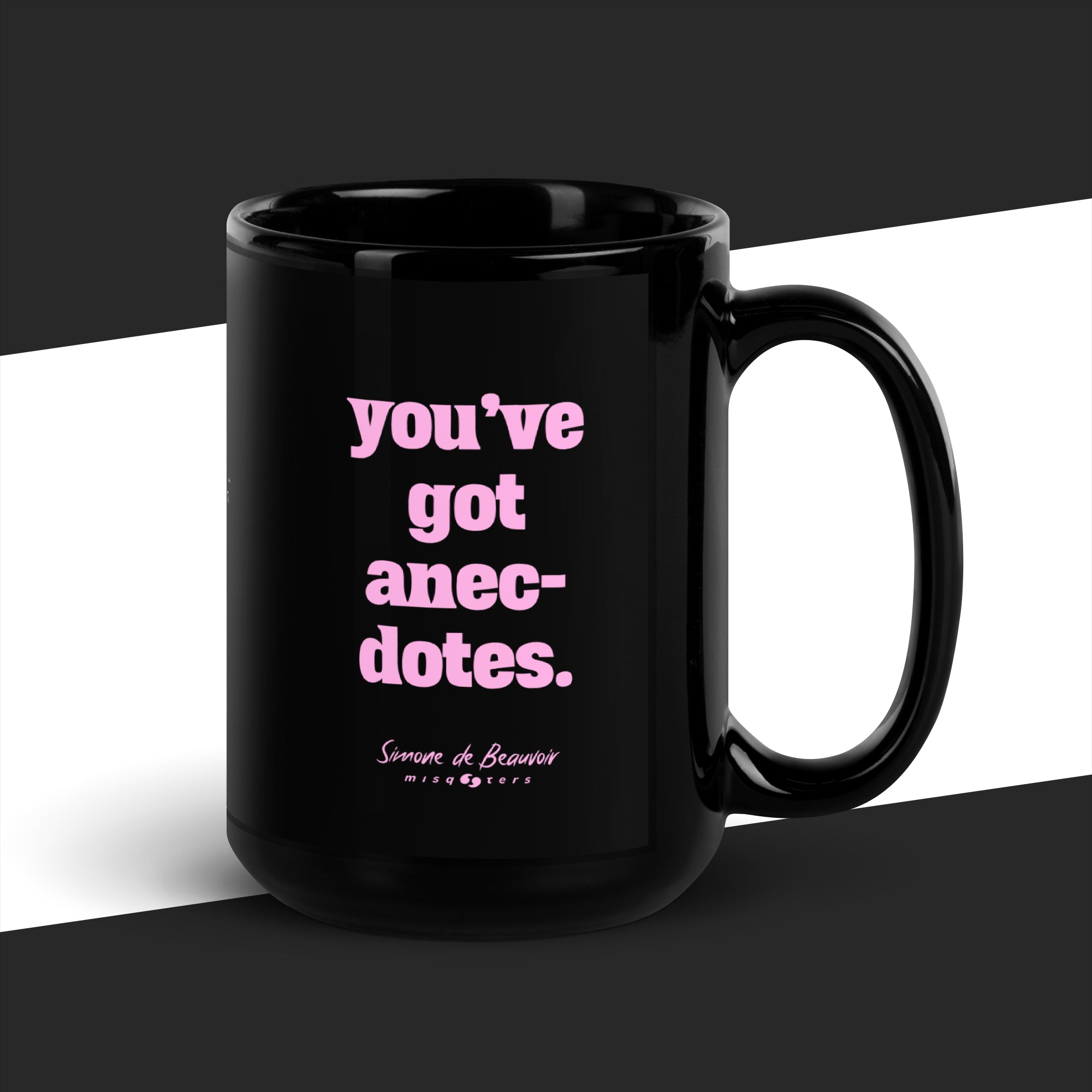 Black mug with pink text on a black and white background