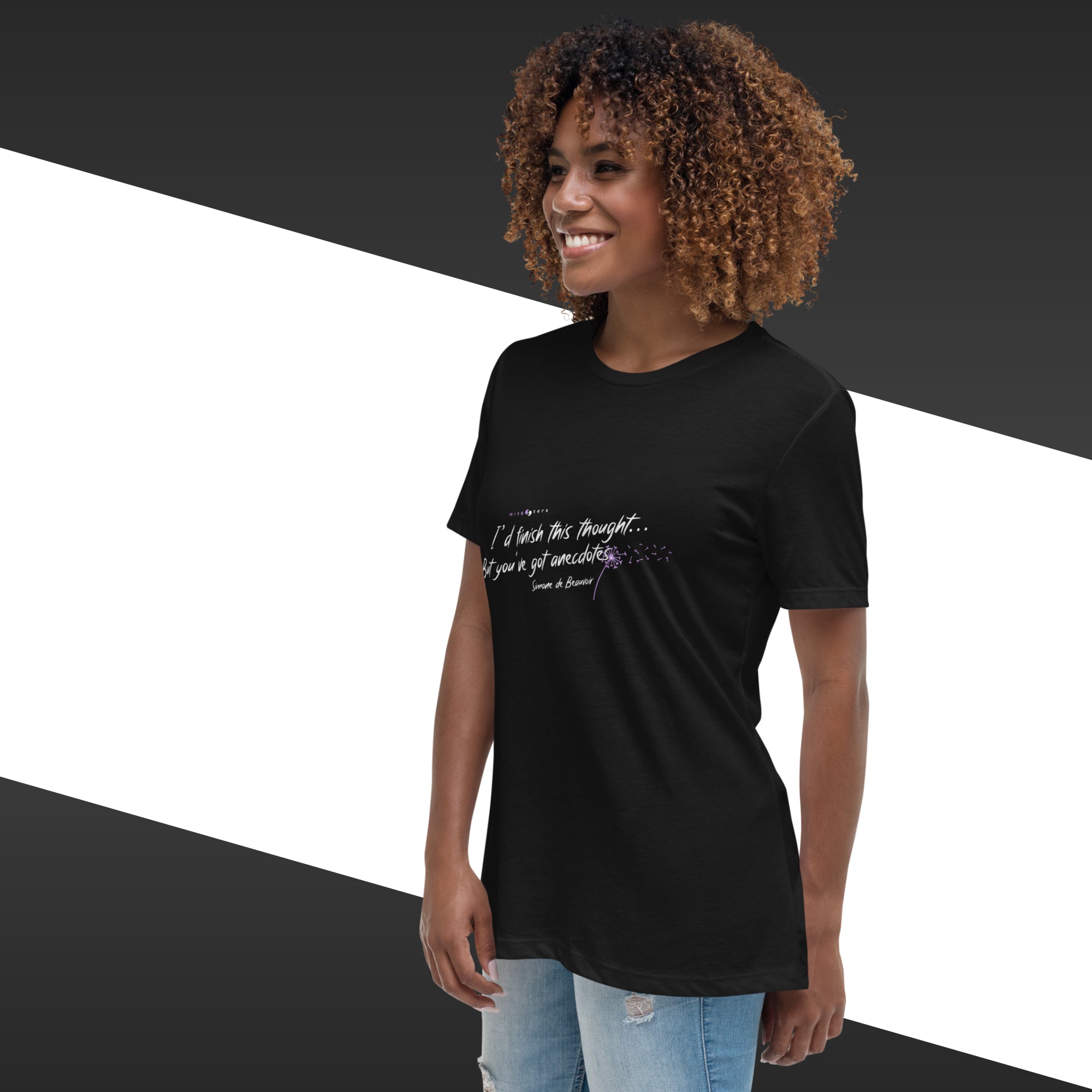 Person wearing a black t-shirt with text on a geometric background