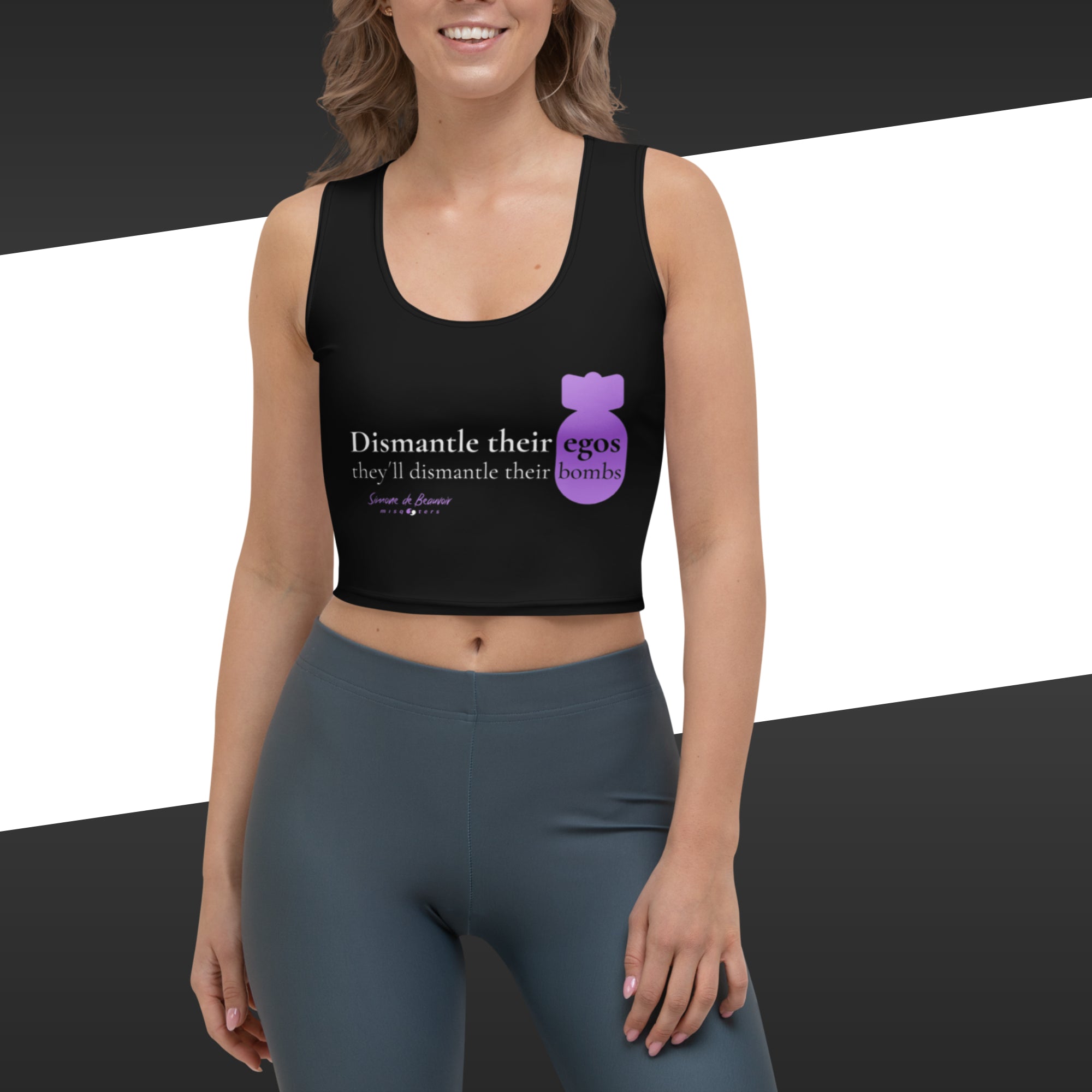Woman wearing a black tank top with purple graphic featuring the fake quote "Dismantle their egos and they´ll dismantle their bombs" by Simone de Beauvoir.