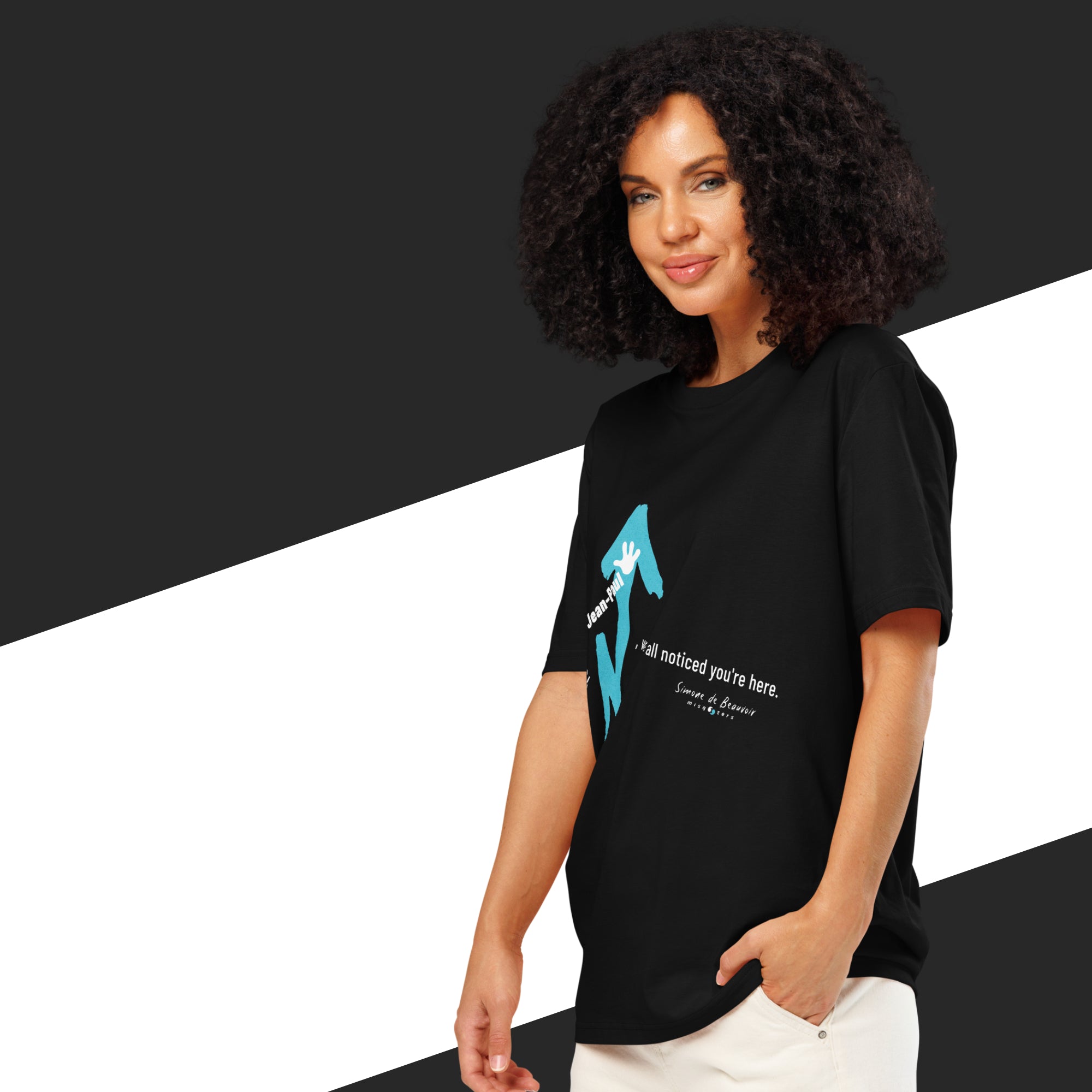 Woman wearing a black t-shirt with a graphic design on a black and white background
