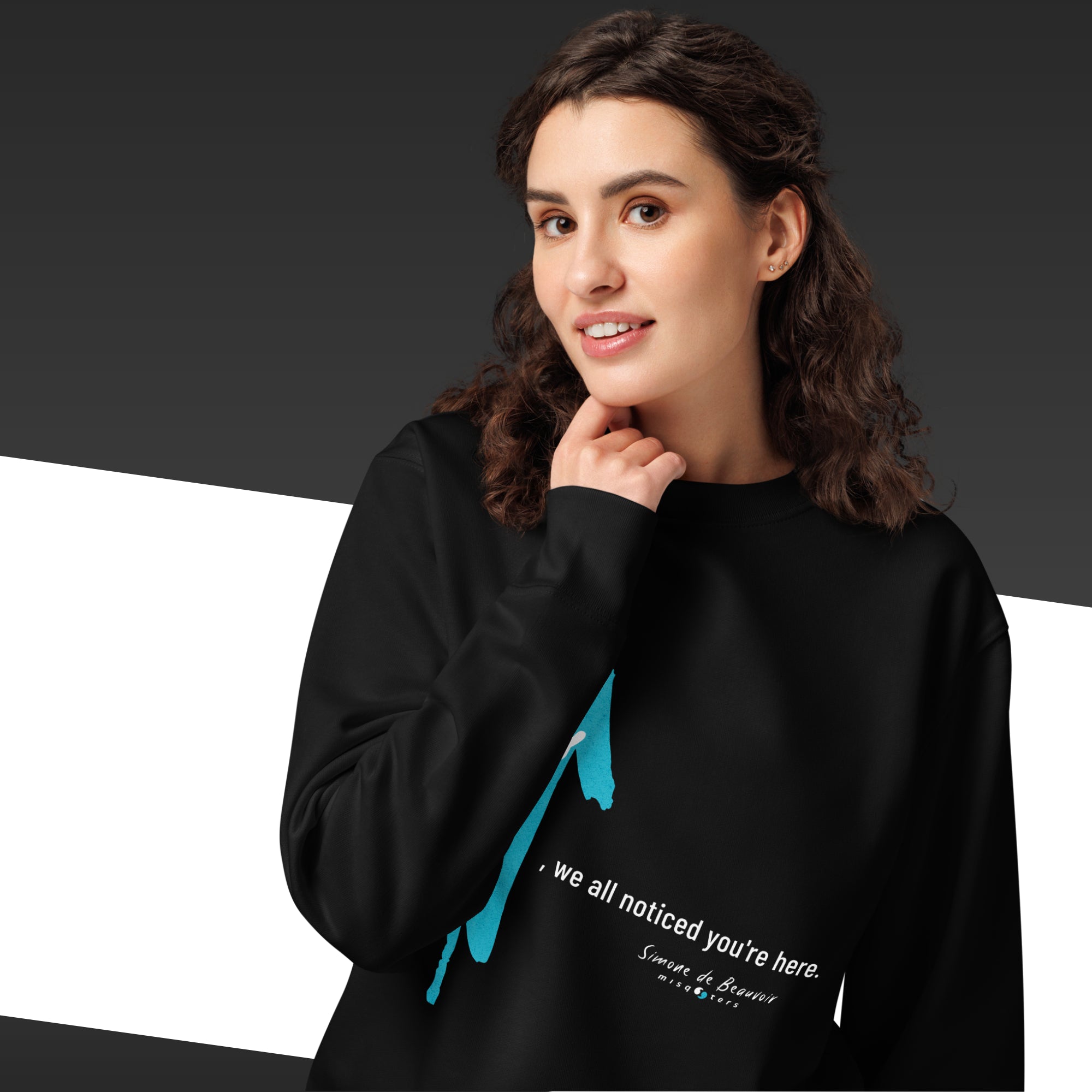 Woman wearing a black hoodie with a blue graphic and text on a dark background