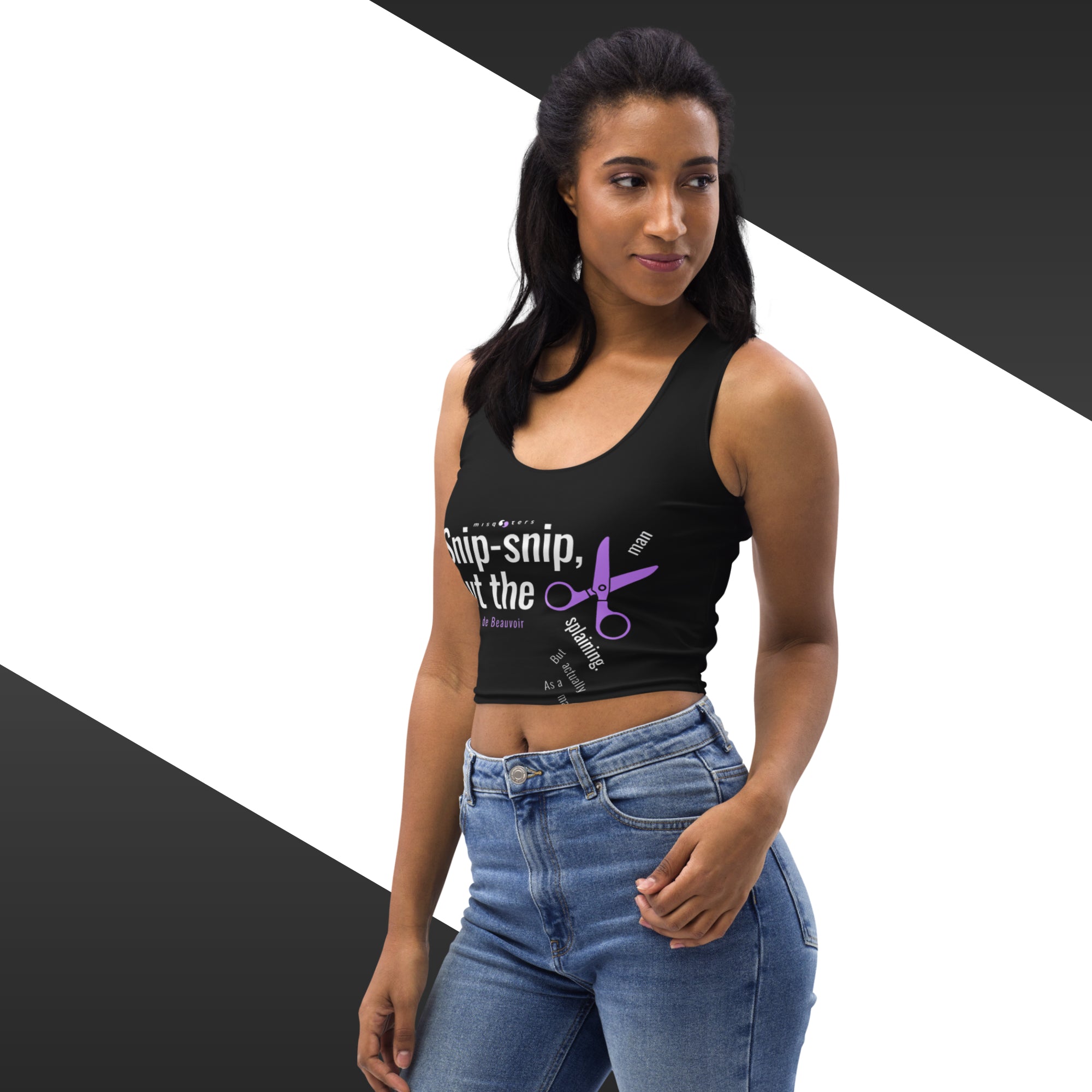 Woman wearing a black crop top with text and graphics, standing against a geometric background.