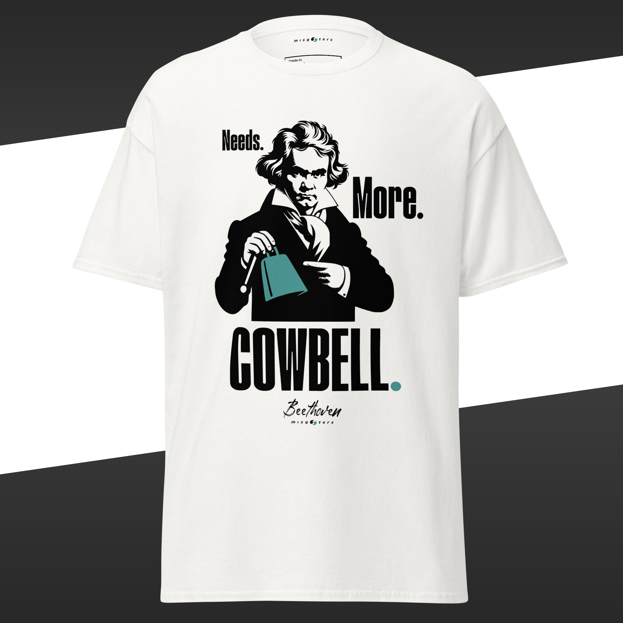 White t-shirt with a graphic of Beethoven holding a green cowbell and fake quote 'Needs More Cowbell' on a black and white background.