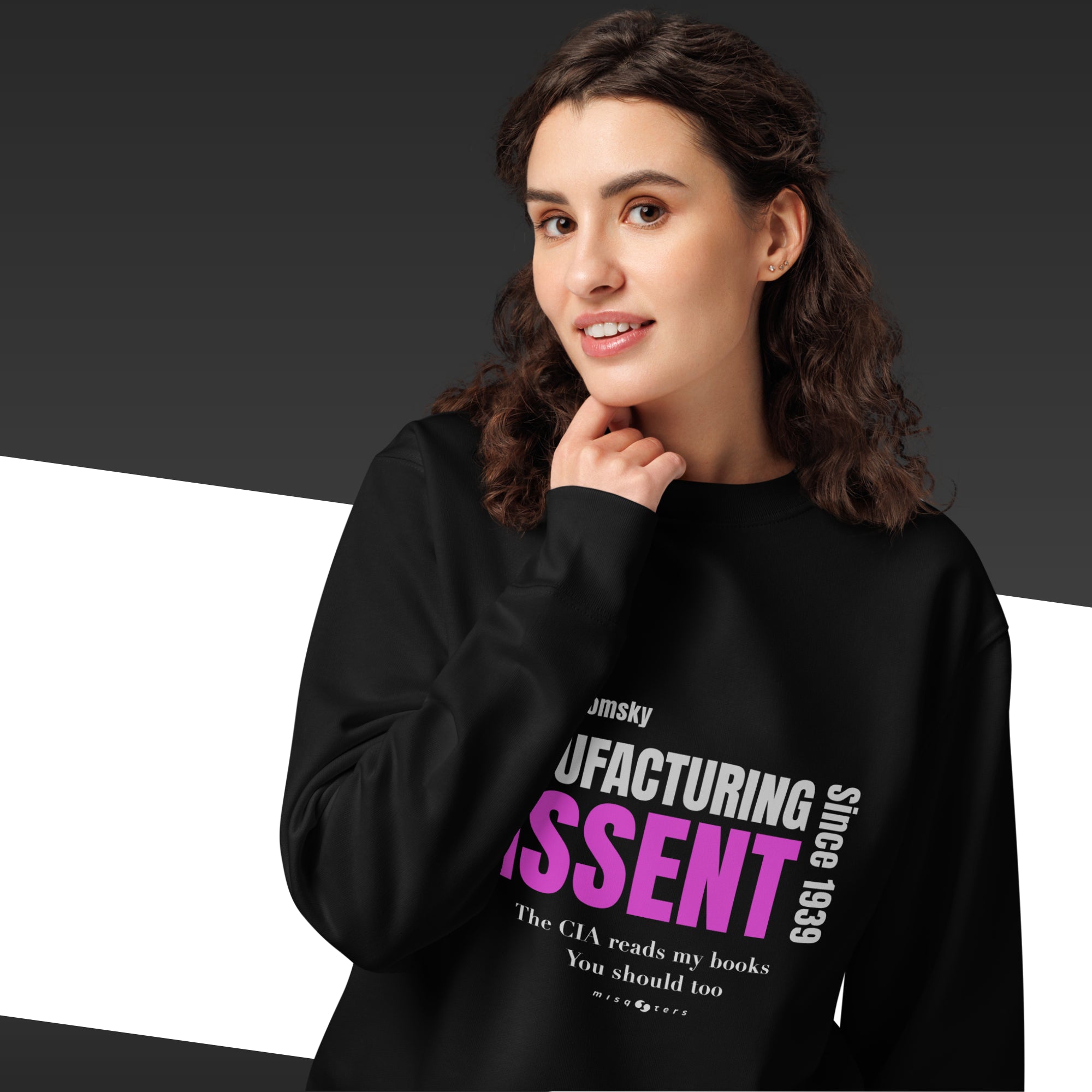 Woman wearing a black sweatshirt with the quote "manufacturing dissent" from Noam Chomsky in purple