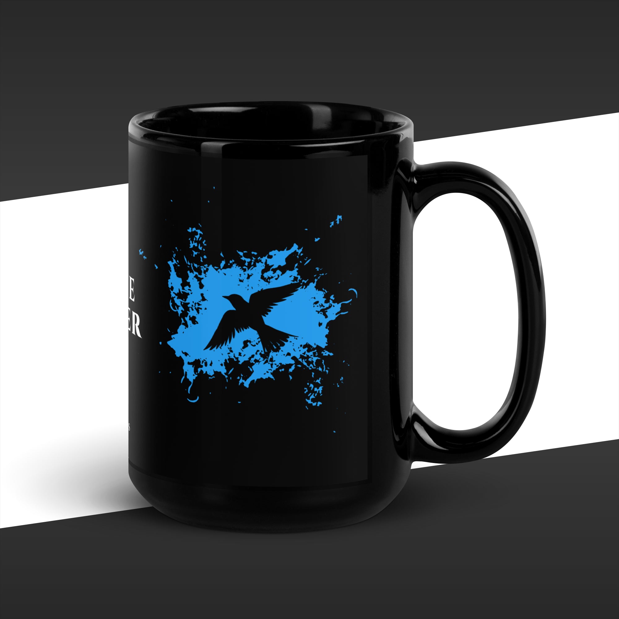 Black mug with blue graphic and white text on a black and white background