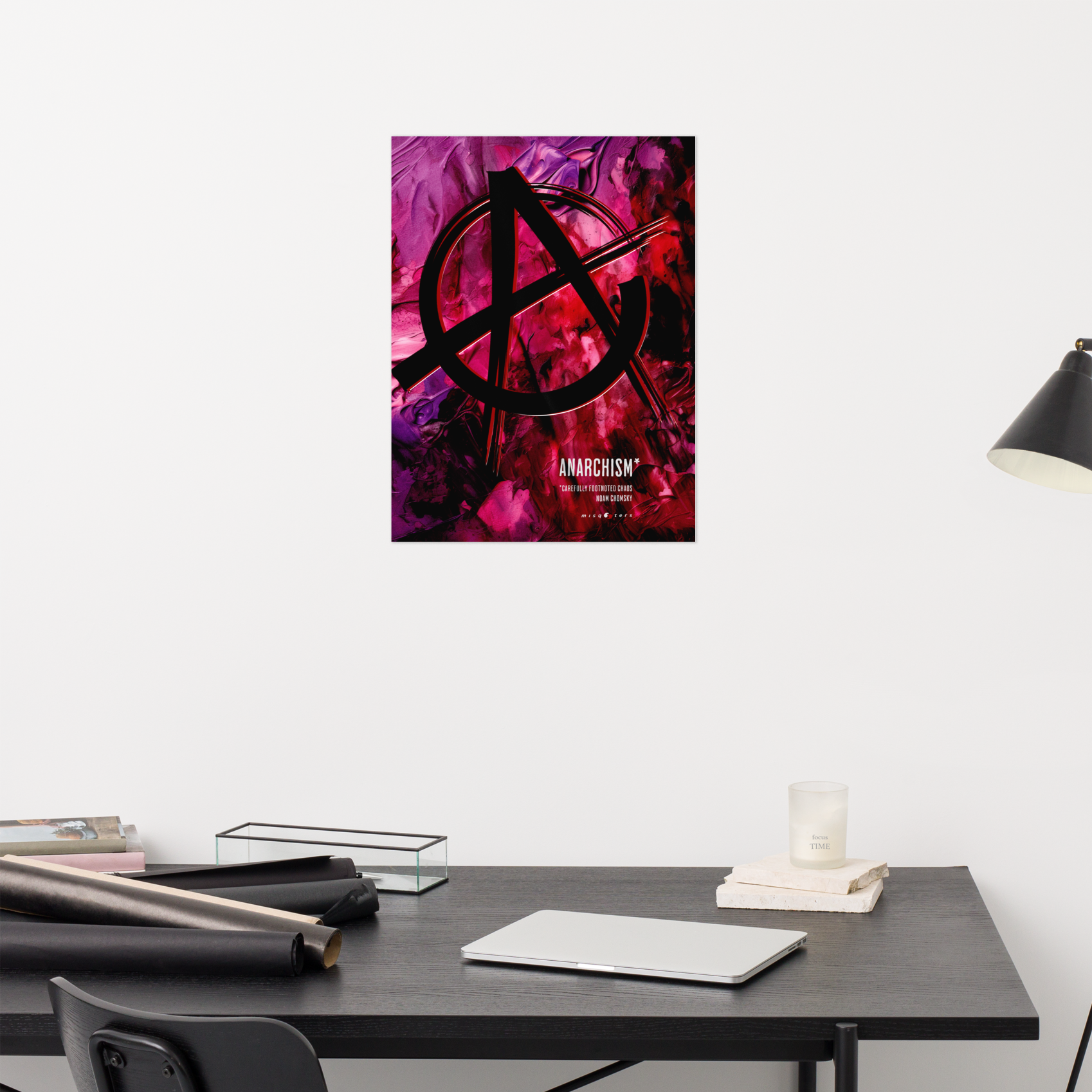 Anarchy symbol poster on a white wall above a desk.