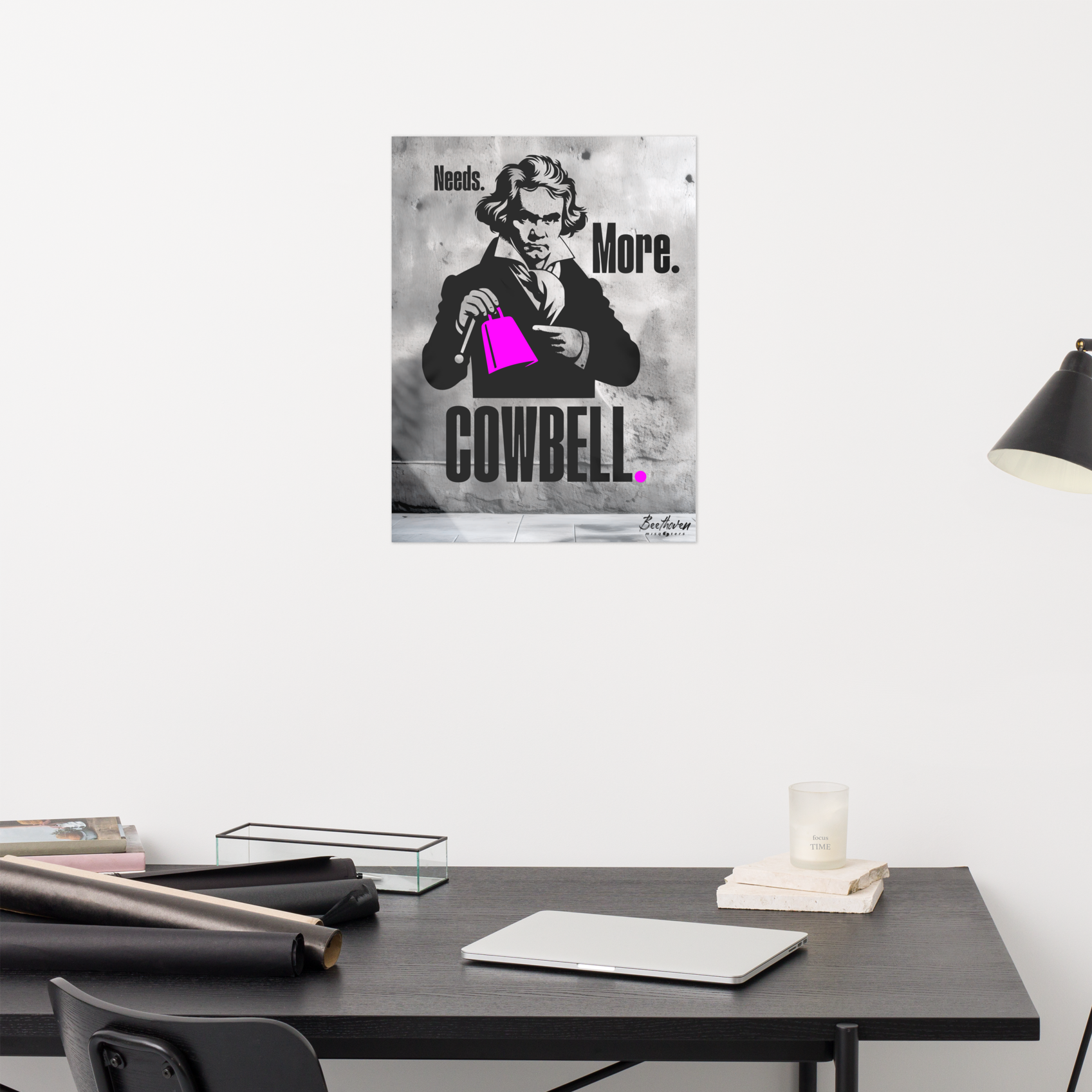 Poster of a man holding a pink object with text on a wall above a desk.