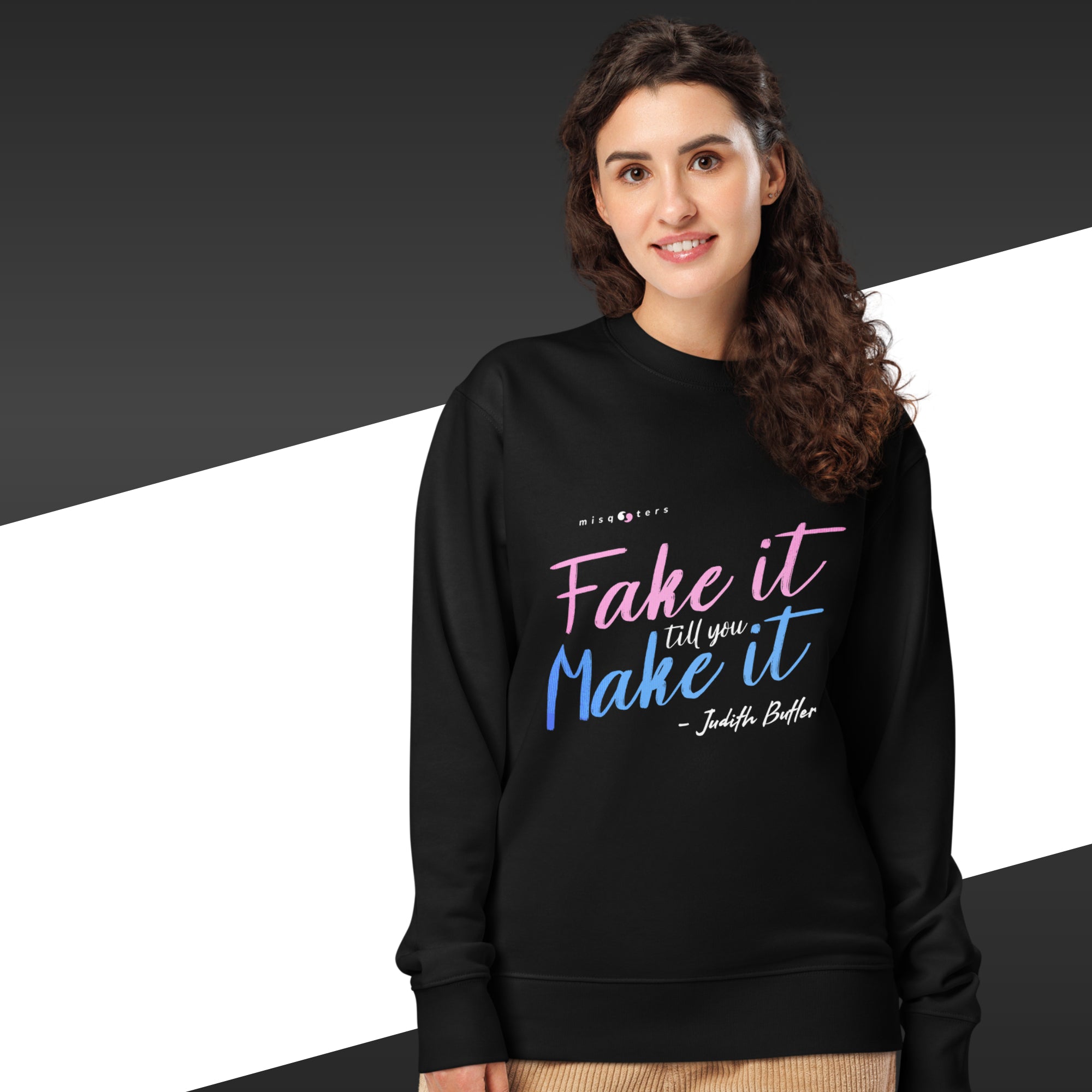 Woman wearing a black sweatshirt with colorful text on a black and white background