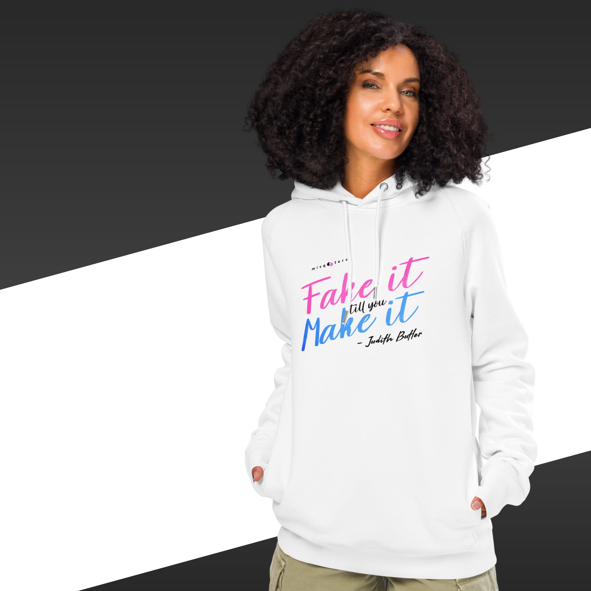 Woman wearing a white hoodie with colorful text on a black and white background