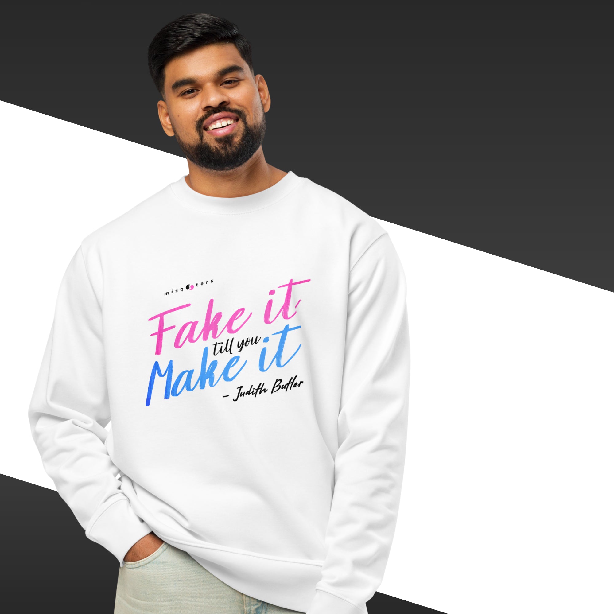 Person wearing a white sweatshirt with colorful text on a black and gray background
