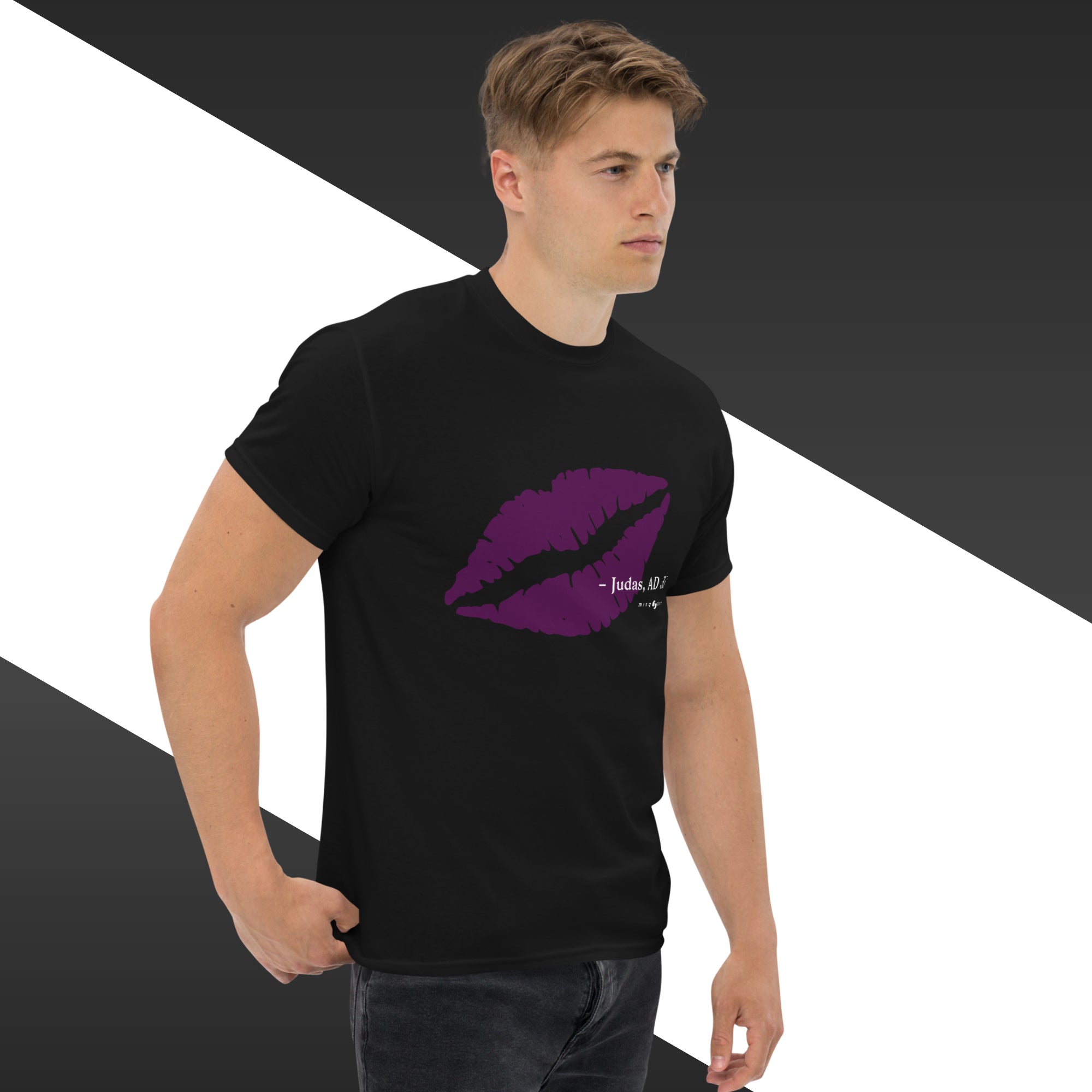 Man wearing a black t-shirt with a purple lip graphic design on a geometric background