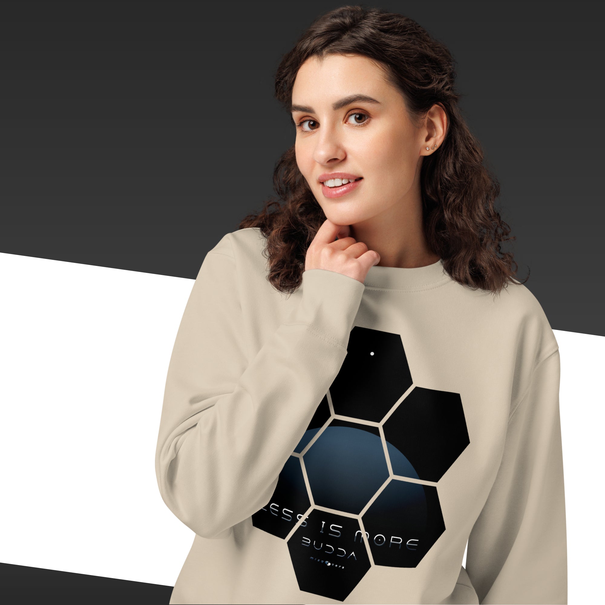 Woman wearing a beige sweatshirt with a geometric design on a black and white background
