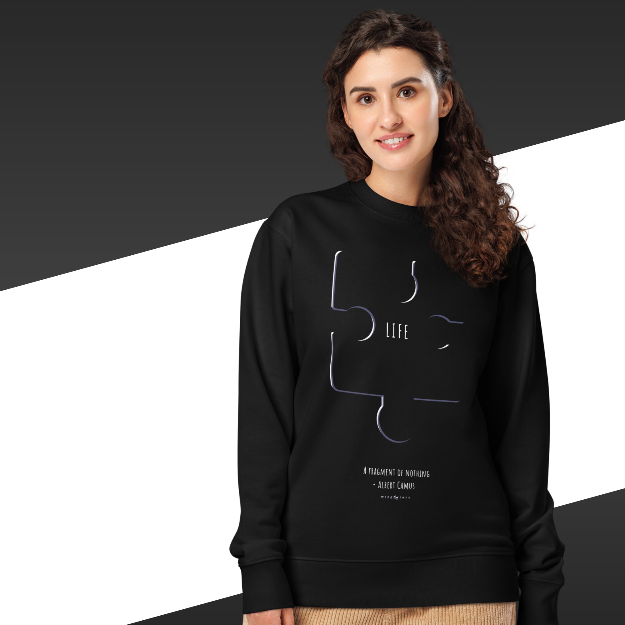 Person wearing a black sweatshirt with a puzzle piece design and text.