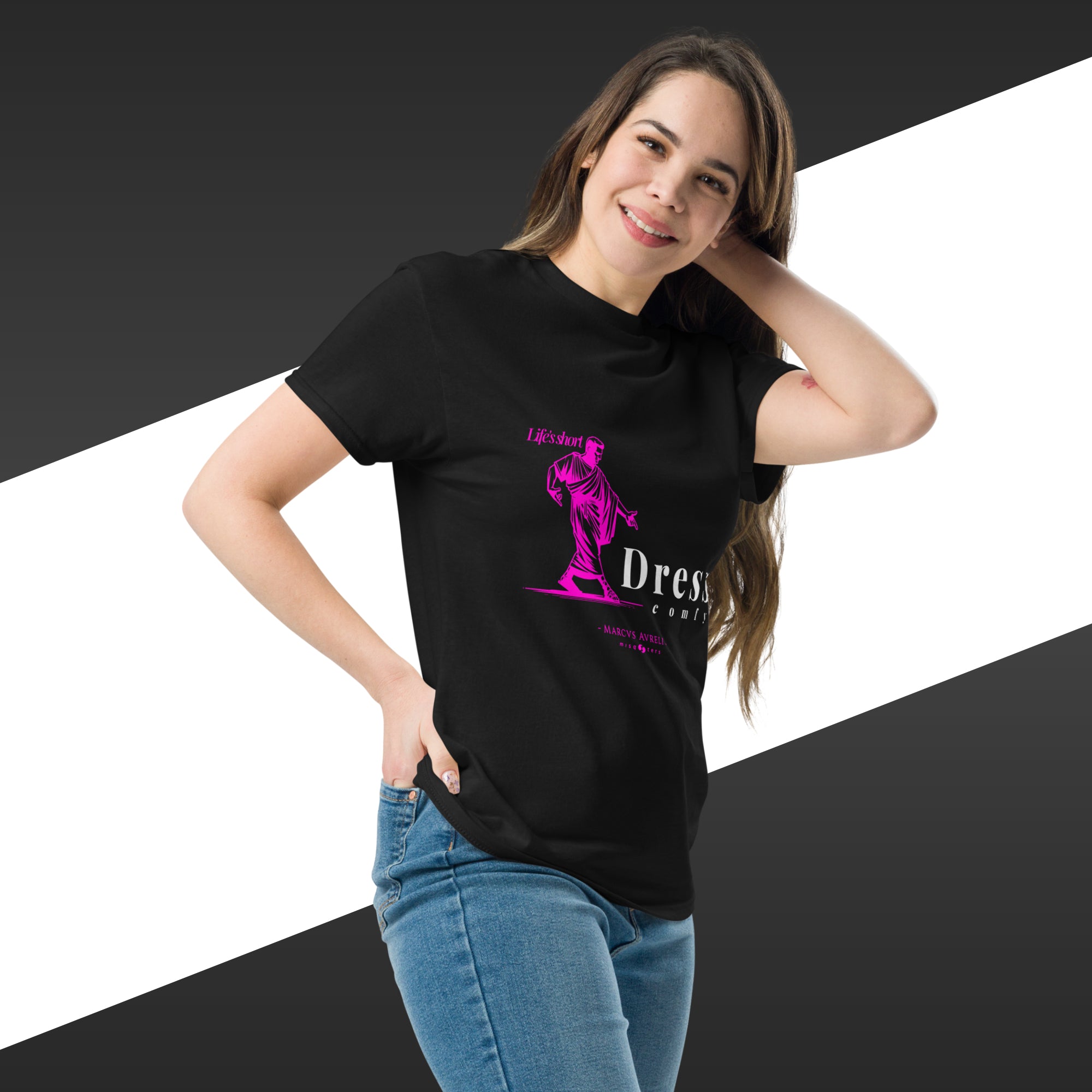 Woman wearing a black t-shirt with a pink graphic design on a white and black striped background