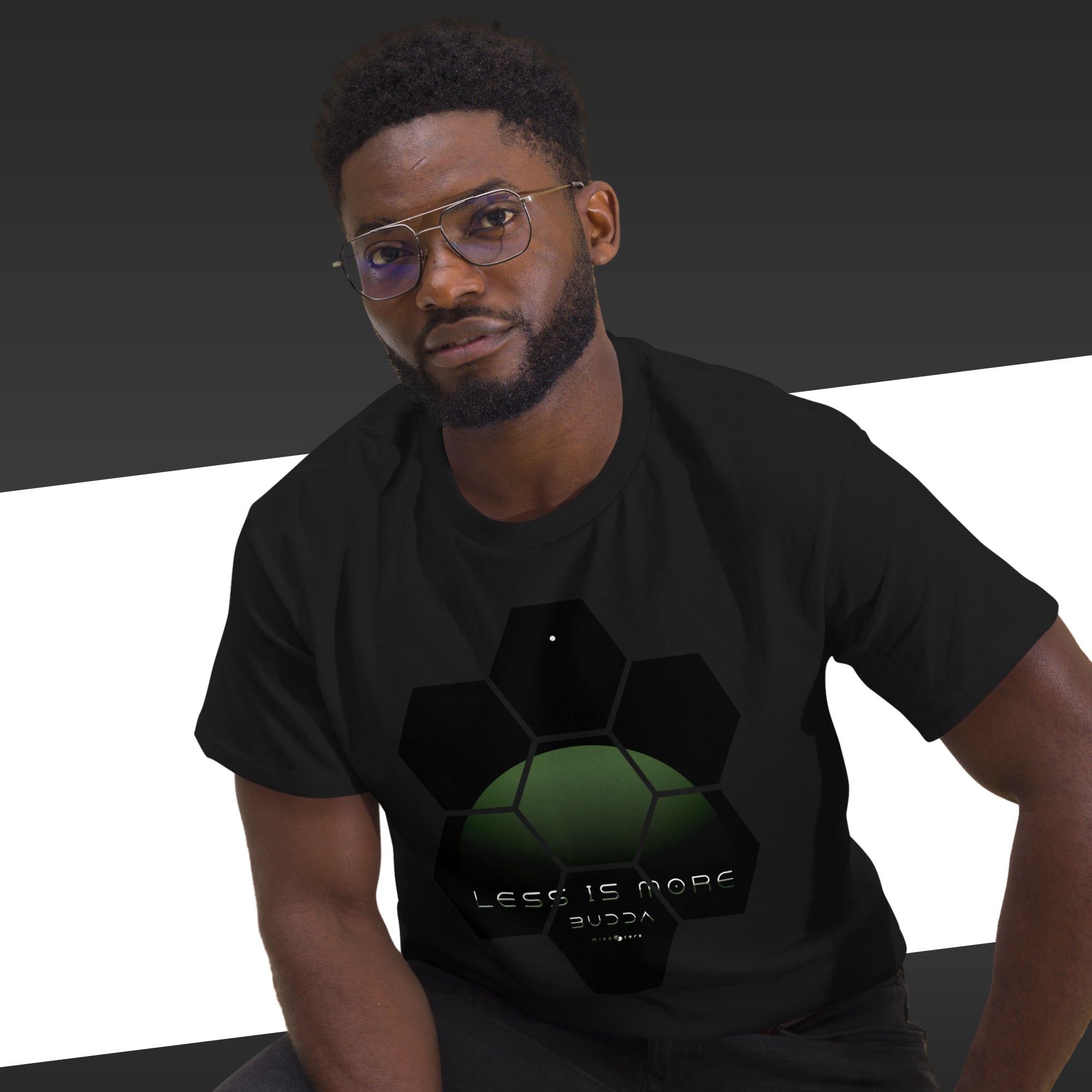 Man wearing a black t-shirt with a green graphic design on a black and white background