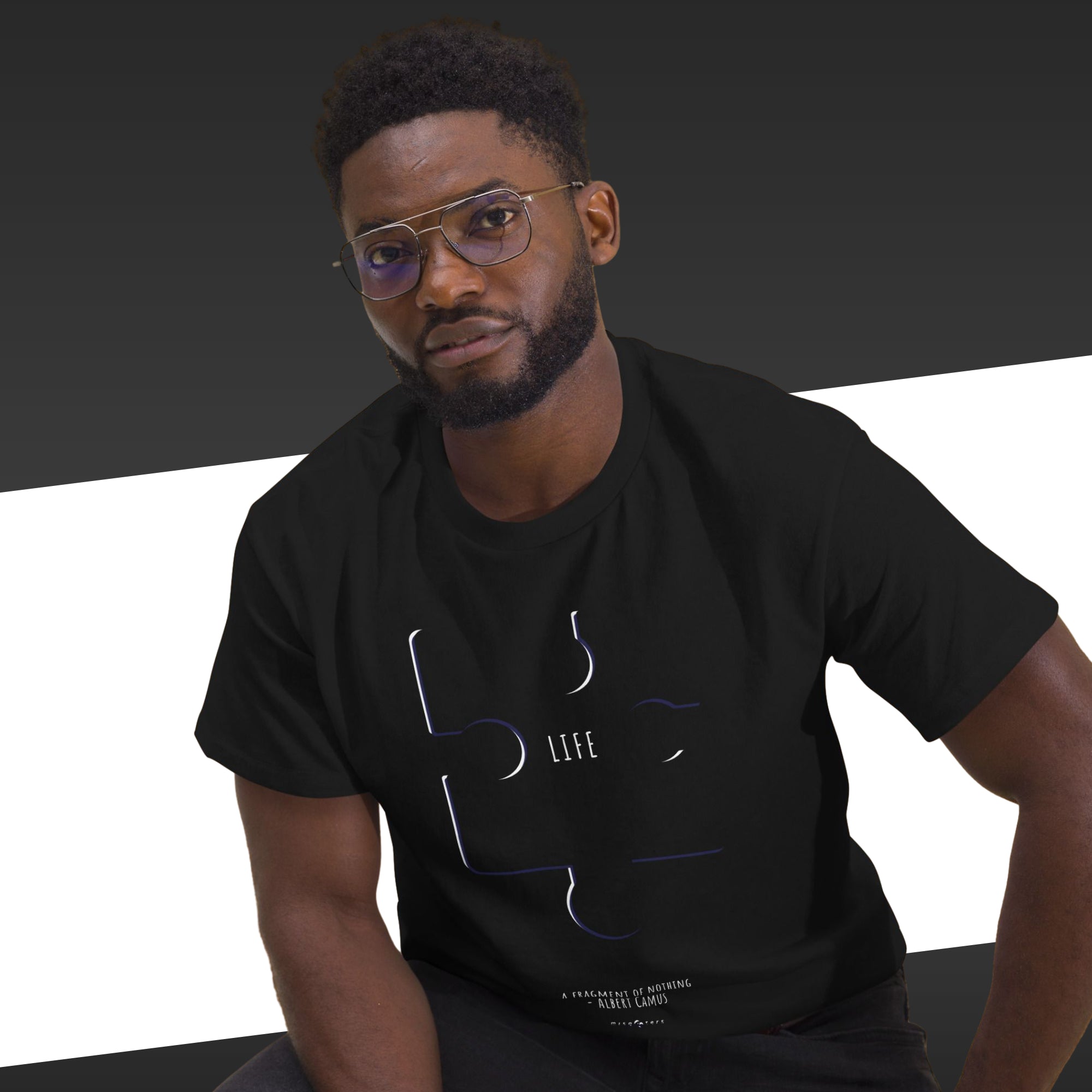 Man wearing a black t-shirt with a graphic design on a black and white background