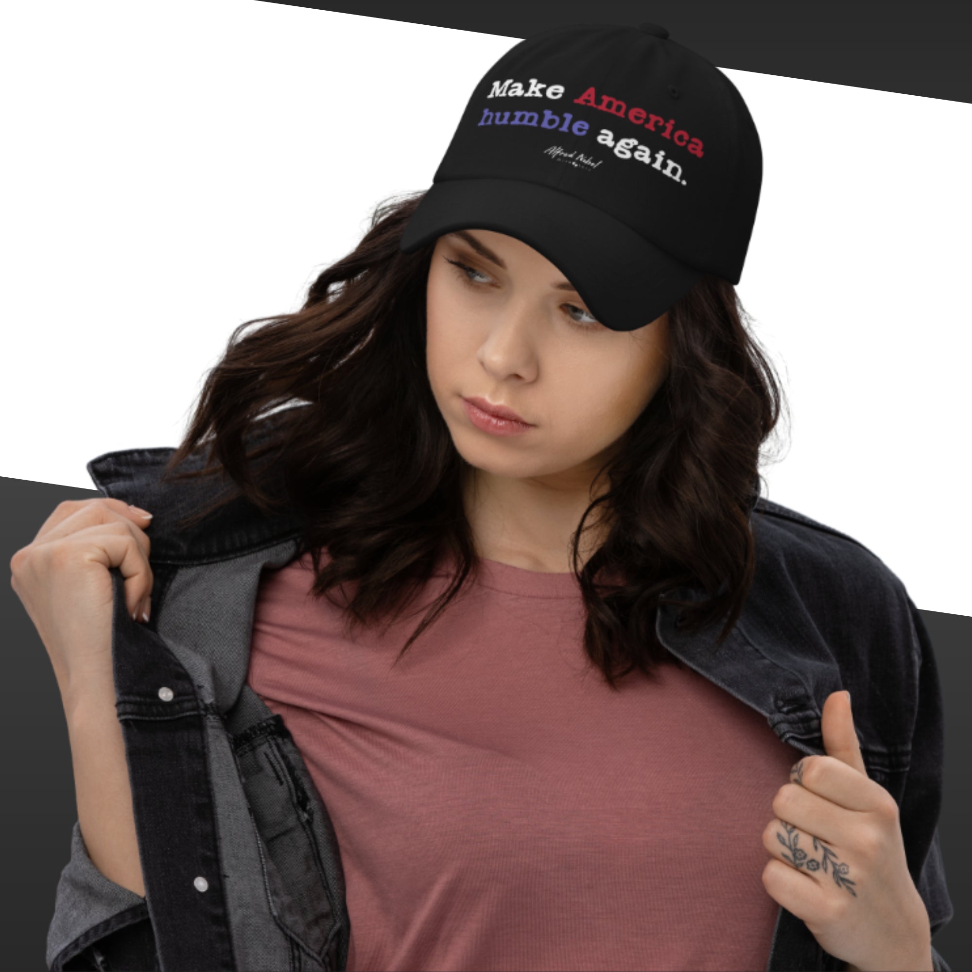 Woman wearing a black cap with text, holding a jacket, on a white background