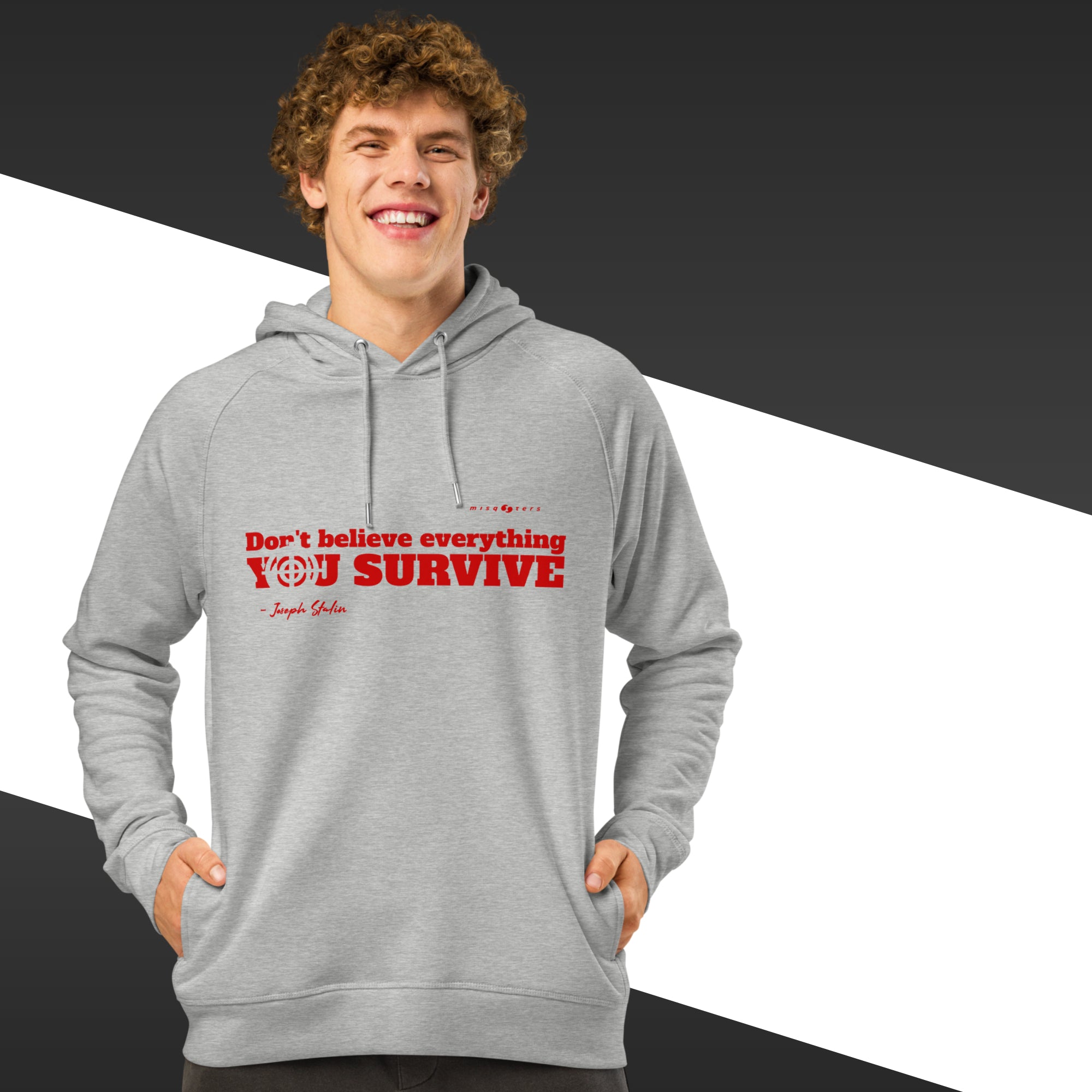 Man with grey hoodie with a red text on and in the background there is black and white stripes